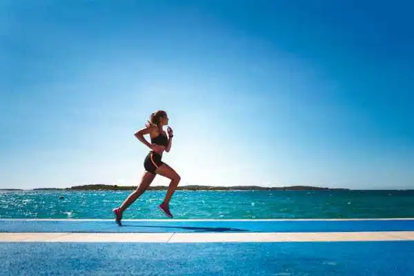 Woman running showing strong leg muscle Chard